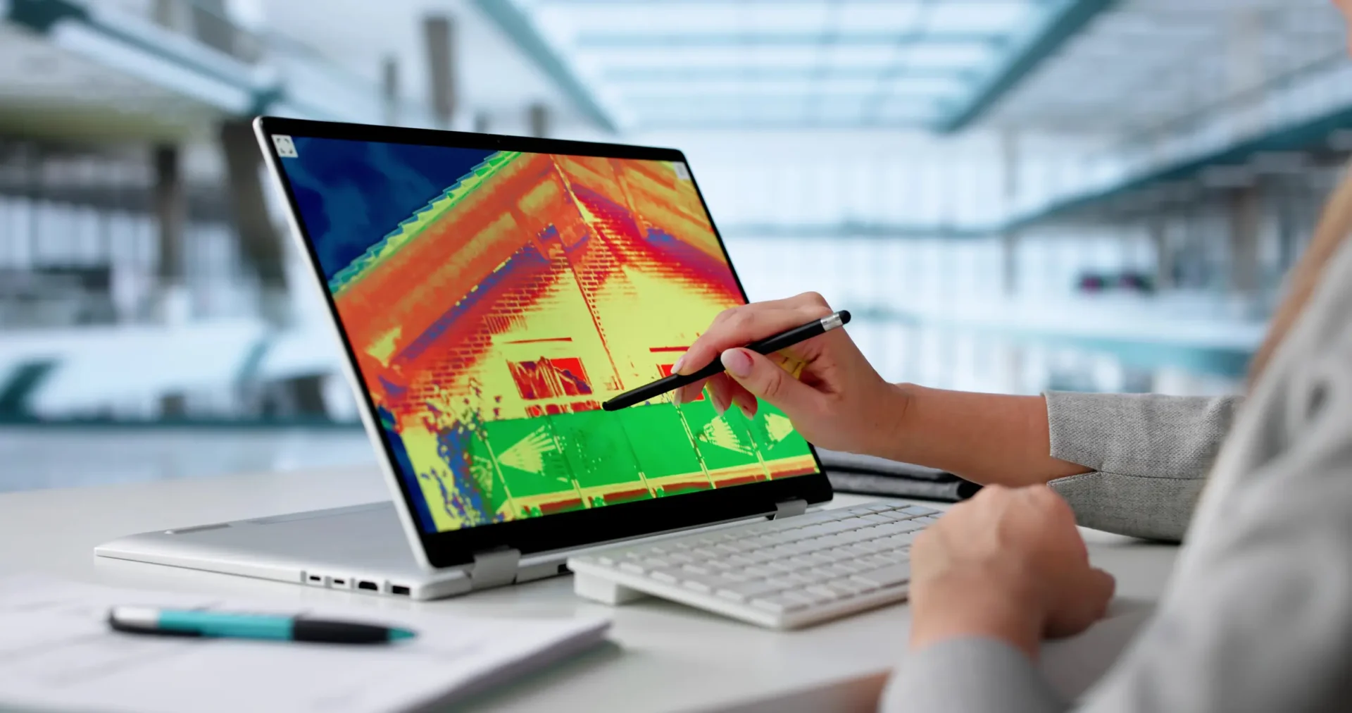 Person analyzing a thermal image on a computer screen.