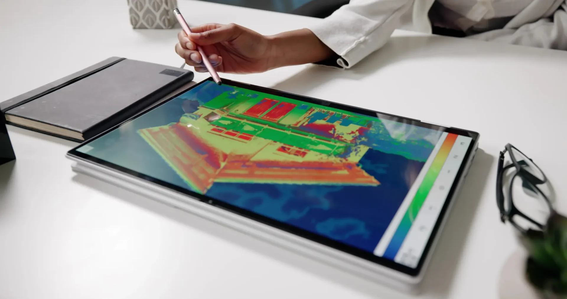 Person using a stylus to draw on a tablet.
