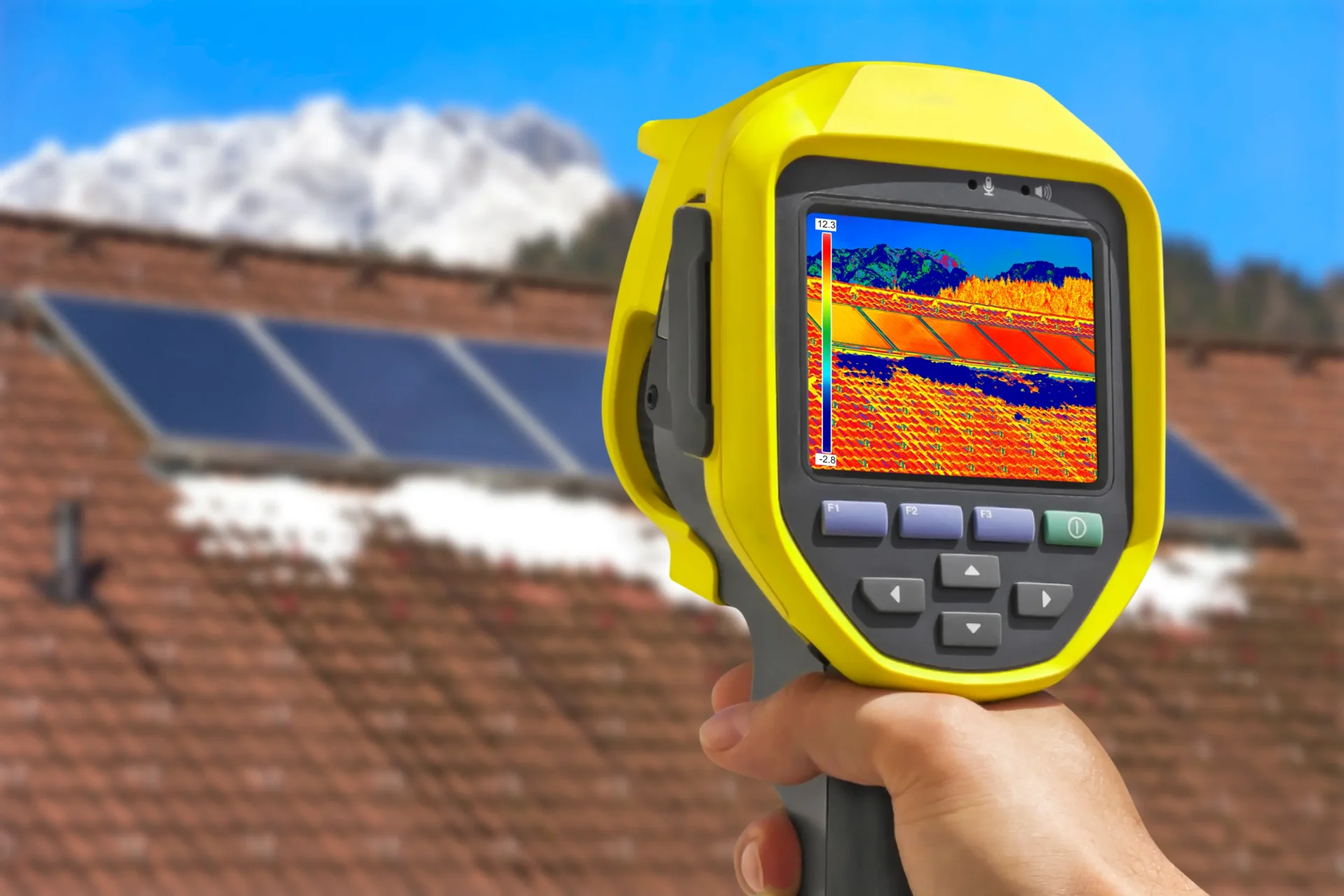 Thermal camera capturing heat patterns on a rooftop with solar panels.