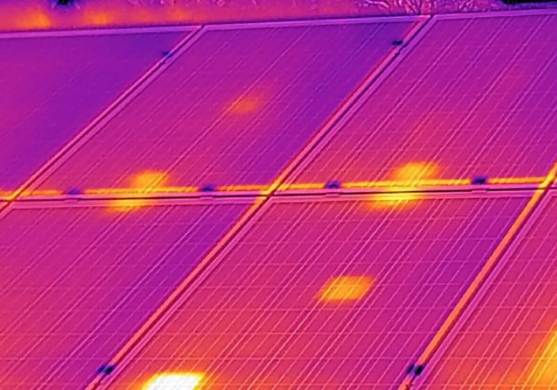 Thermal image showing heat spots on solar panels.